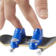 A tiny Hot Wheels Skate fingerboard with a blue pair of tiny skate shoes attached.